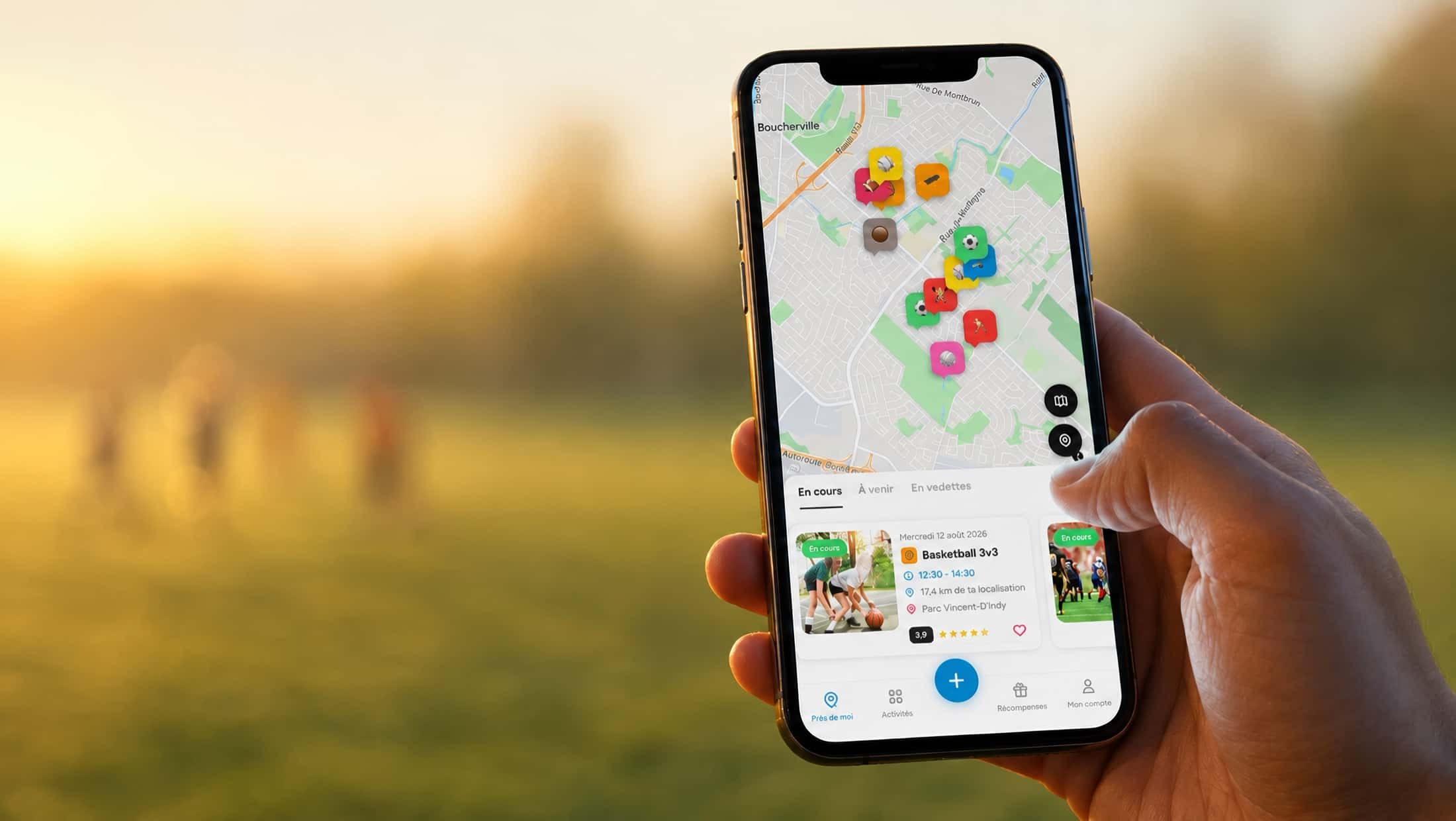 A hand holds a phone in a park at sunset; the Viens Jouer neighbourhood map shows the games under way, with a soccer game in the background.